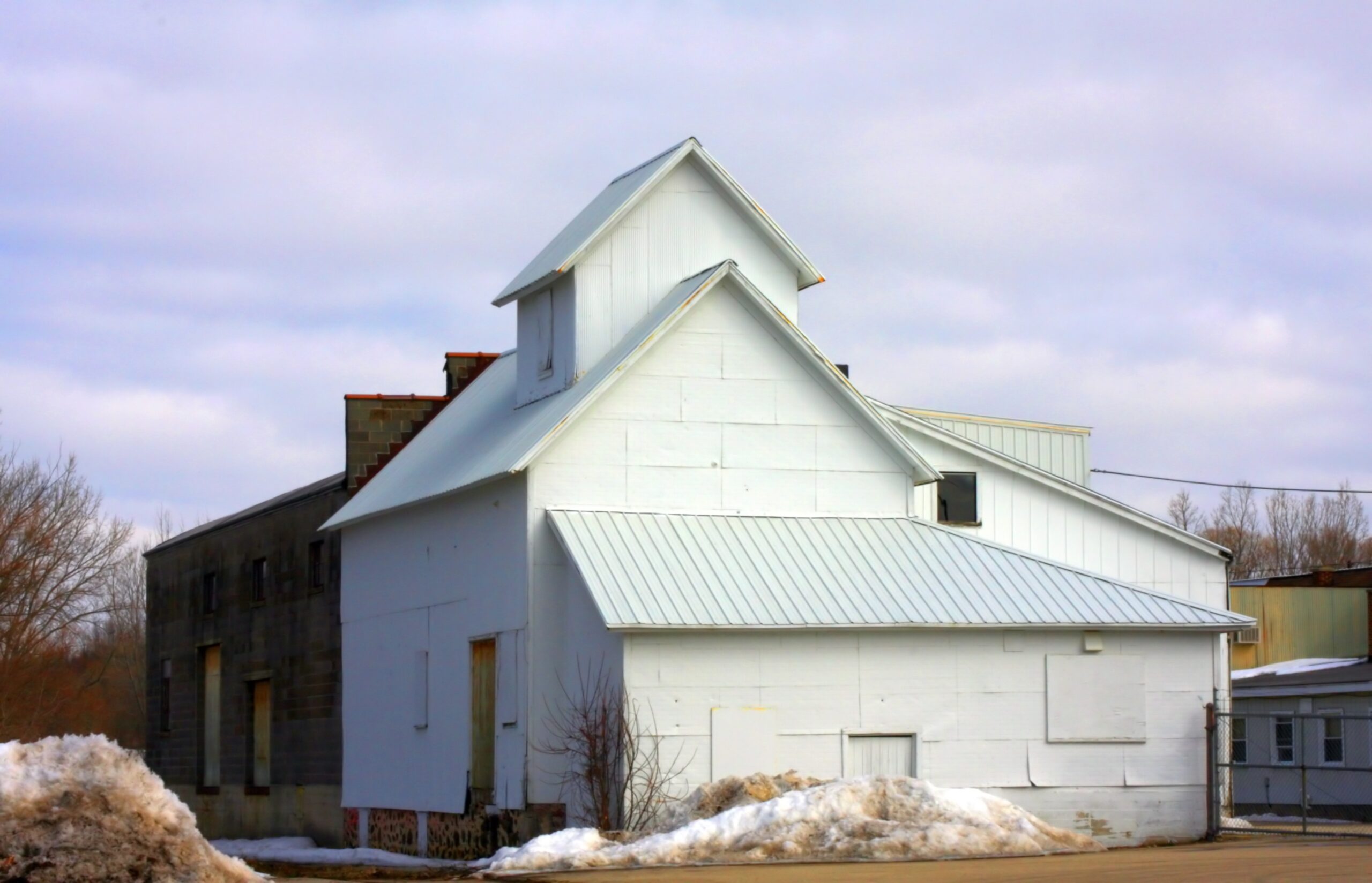 A beautiful shot of a storage house with a cloudy blue sky in the background
